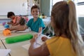 Schoolboy sitting at a desk in an elementary school classroom Royalty Free Stock Photo