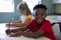 Schoolboy sitting at a desk in an elementary school classroom Royalty Free Stock Photo