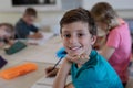 Schoolboy sitting at a desk in an elementary school classroom Royalty Free Stock Photo