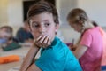 Schoolboy sitting at a desk in an elementary school classroom Royalty Free Stock Photo