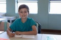 Schoolboy sitting at a desk in an elementary school classroom Royalty Free Stock Photo