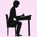 Schoolboy sitting at a school desk