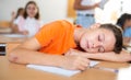 Schoolboy sleeping on desk in classroom Royalty Free Stock Photo