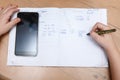 Schoolboy with smartphone doing homework at home Royalty Free Stock Photo