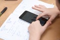 Schoolboy with smartphone doing homework at home Royalty Free Stock Photo