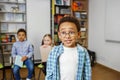 Schoolboy standing in middle of classroom and answering question in front of classmates and teacher Royalty Free Stock Photo