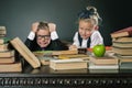 Schoolboy in stress or depression at school classroom, schoolgirl helps Royalty Free Stock Photo