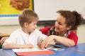 Schoolboy Studying In Classroom With Teacher