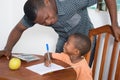 Schoolboy studying with his home teacher.