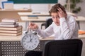 Male pupil in time management concept Royalty Free Stock Photo