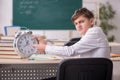 Male pupil in time management concept Royalty Free Stock Photo