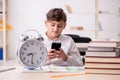 Male pupil in time management concept Royalty Free Stock Photo