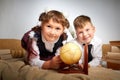 A schoolboy in uniform having fun and rest with a globe in the room. A boy and girl during fun photo shoot about school Royalty Free Stock Photo