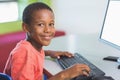 Schoolboy using computer in classroom Royalty Free Stock Photo