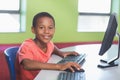 Schoolboy using computer in classroom Royalty Free Stock Photo