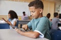 Schoolboy using tablet in elementary school class, close up