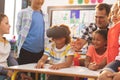 Schoolboy using virtual reality headset with his classmate and teacher Royalty Free Stock Photo