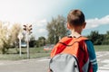 Schoolboy waiting at zebra crossing