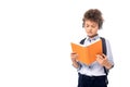 Schoolboy in wireless headphones reading book