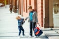 Schoolboys with backpack going to school. Stylish brothers outdoors. Primary school