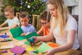 Preschool kids trying to concentrate on the teacher`s task Royalty Free Stock Photo