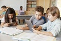 Schoolboys working together with tablet computer in class Royalty Free Stock Photo