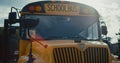 Schoolbus front staying on empty parking with yellow sign image children closeup Royalty Free Stock Photo