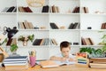 Schoolchild doing homework at his desk Royalty Free Stock Photo