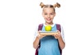 schoolchild holding apple on books