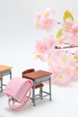 Schoolchild`s rucksacks and cherry blossoms on white background. Pink randoseru. Royalty Free Stock Photo