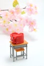 Schoolchild`s rucksacks and cherry blossoms on white background. Red randoseru. Royalty Free Stock Photo