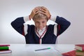 Schoolchild touching his head