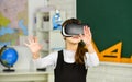 Schoolchild using virtual reality. virtual reality headset. teenage schoolgirl in classroom. back to school. In a Royalty Free Stock Photo