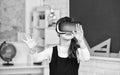 schoolchild using virtual reality. virtual reality headset. teenage schoolgirl in classroom. back to school. In a Royalty Free Stock Photo