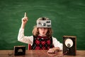 Schoolchild with virtual reality headset in class