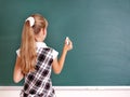 Schoolchild writing on blackboard. Royalty Free Stock Photo