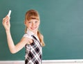 Schoolchild writing on blackboard.