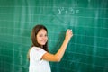 Schoolchild writing on blackboard. Royalty Free Stock Photo