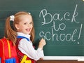 Schoolchild writting on blackboard.