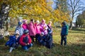 schoolchildren in the autumn park,beautiful children under the tree in autumn, yellow leaves on the tree, 3.11.2014. Ukraine