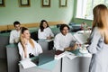 Schoolchildren at biology lesson at school with DNA model on the table. Biology teacher gives a lesson to pupils in Royalty Free Stock Photo