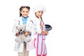 schoolchildren in costumes of doctor and chef standing in white coat and apron