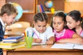 Schoolchildren having fun in classroom Royalty Free Stock Photo