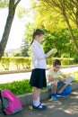 Schoolchildren outdoors, in the park, read books and do homework Royalty Free Stock Photo