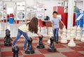 Schoolchildren playing giant chess at a science centre