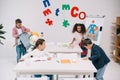 Schoolchildren preparing for lesson in classroom