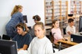 Schoolchildren preparing for lessons on the computer