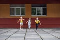 Schoolchildren run from school. Classmates with backpacks. Beginning of school lessons Royalty Free Stock Photo