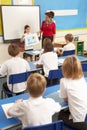 Schoolchildren Studying In Classroom With Teacher Royalty Free Stock Photo