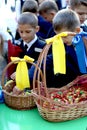 Schoolchildren take treats in purses on September 1